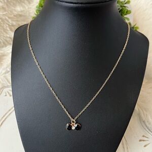 Fashion gold tone necklace with mini black enamel pendant